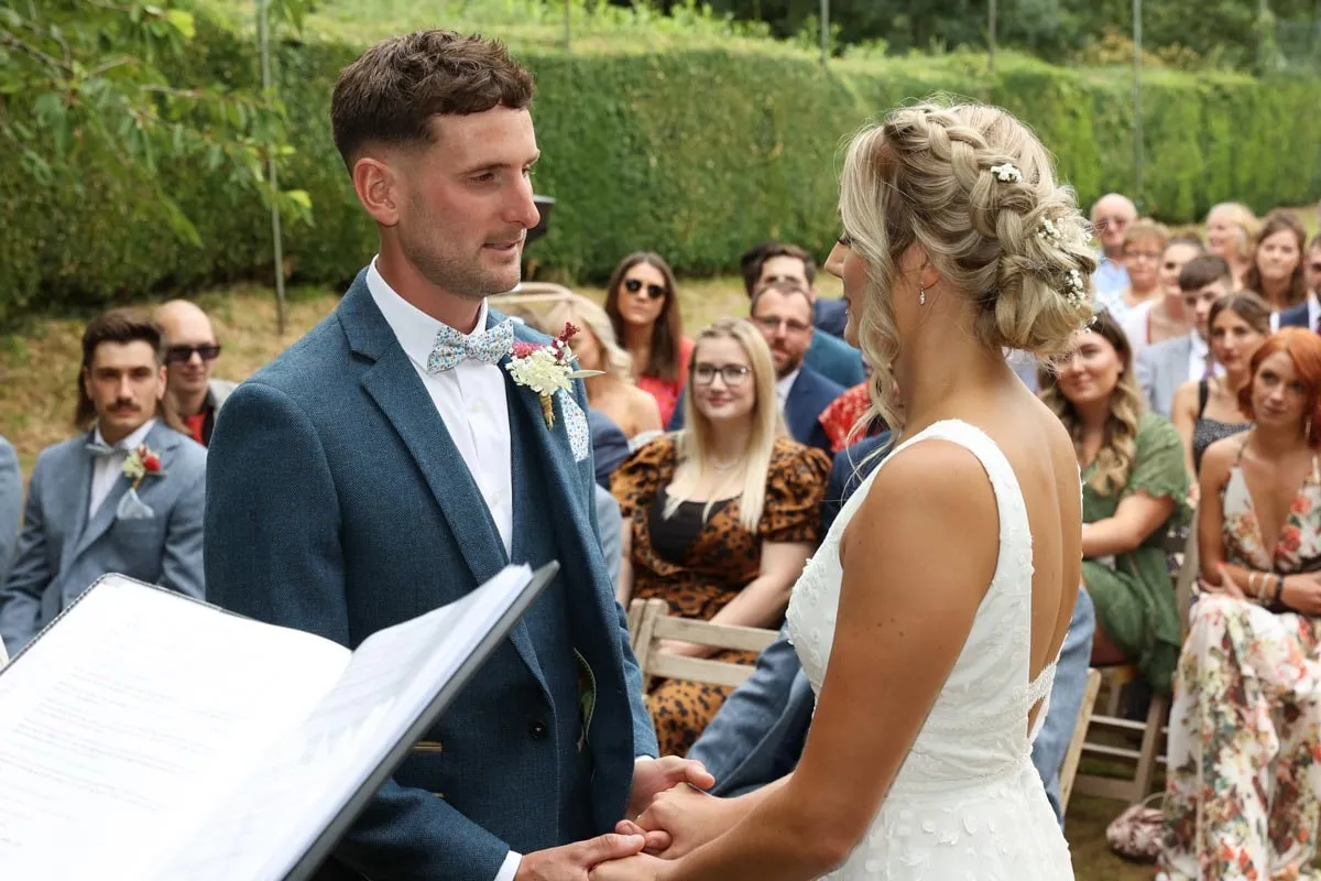 Outdoor wedding vows in the gardens at Pennard House