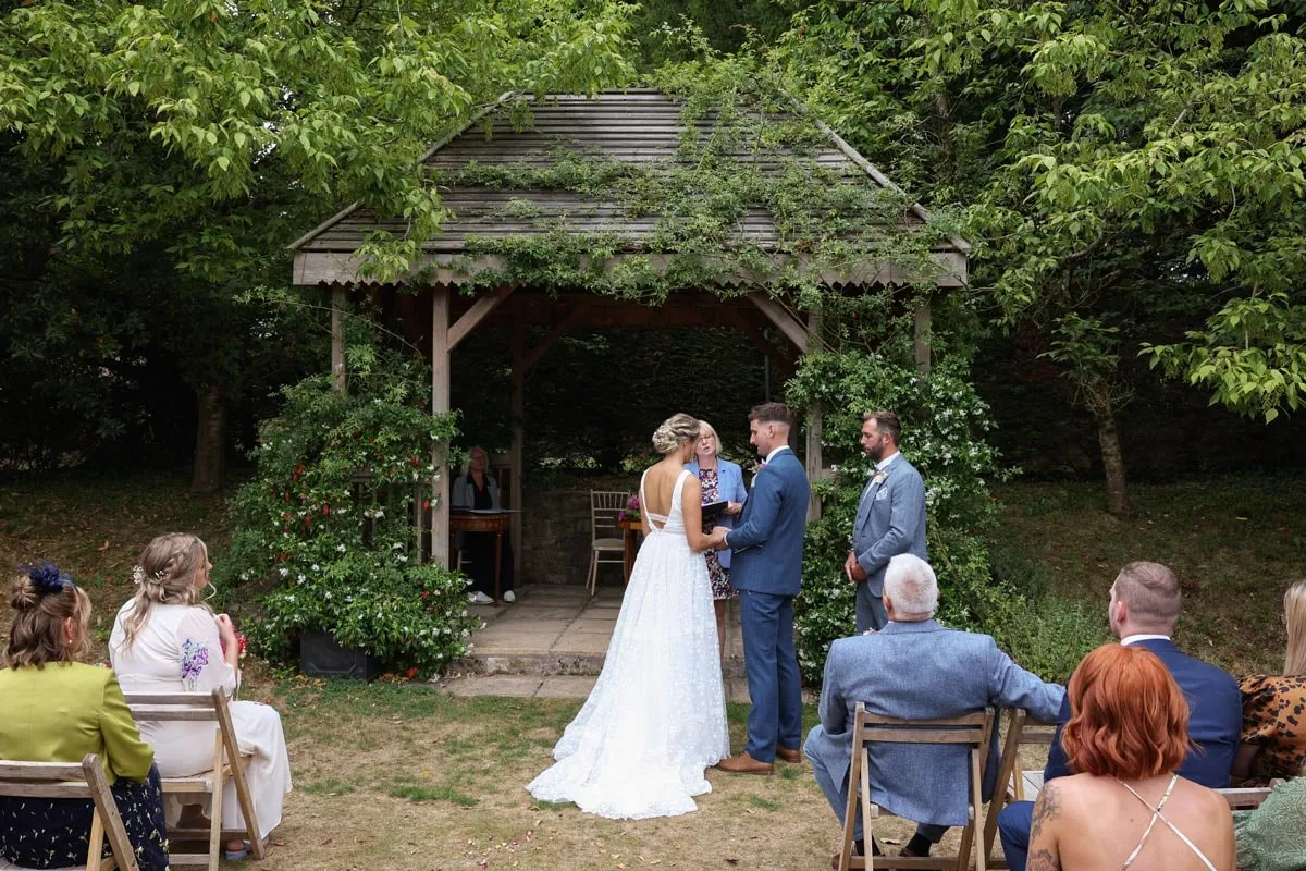 An outdoor ceremony in the gardens at Pennard House