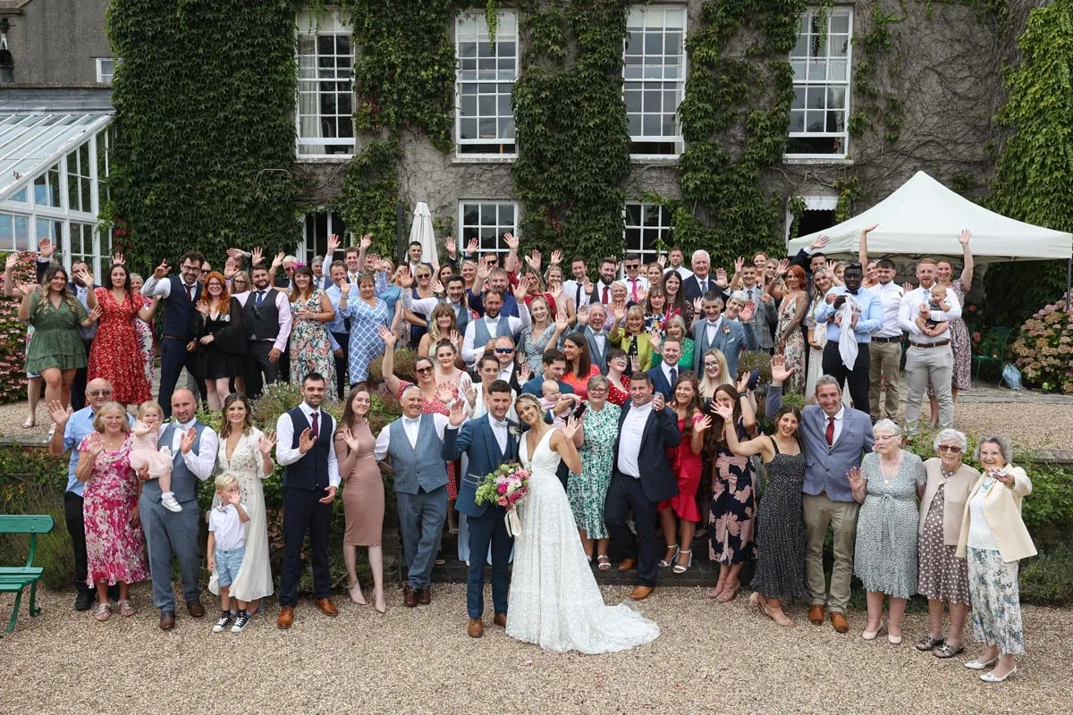 The whole wedding party in front of Pennard House