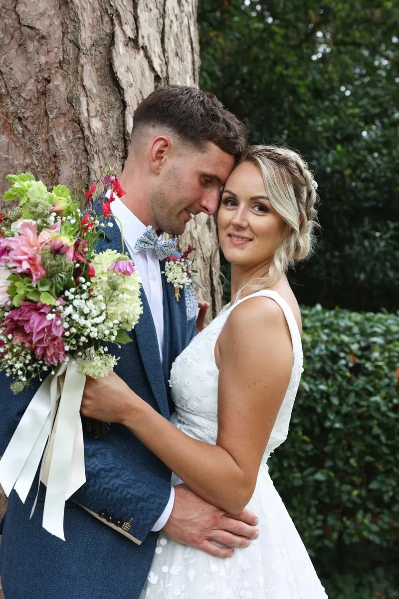 Couple embracing in the gardens at Pennard House