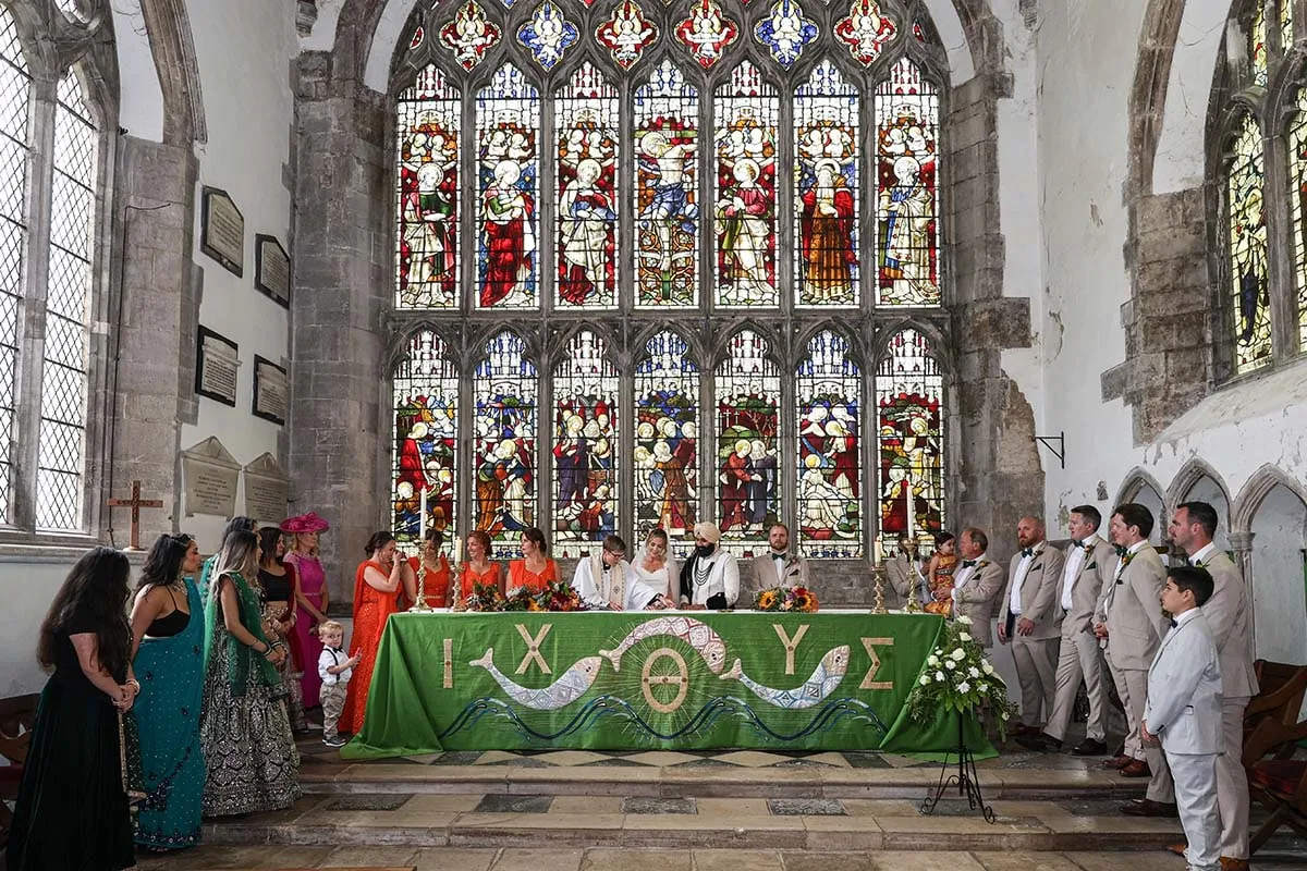 Wedding ceremony beneath a stained glass window