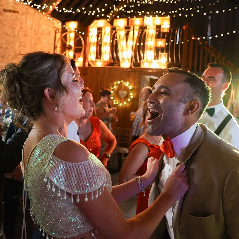 Guests dancing under LOVE letters at an evening reception