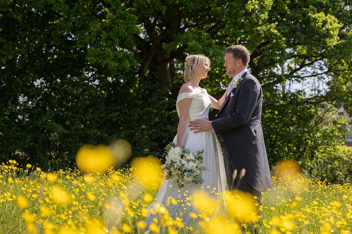 Couple photographed among buttercups at their Somerset wedding