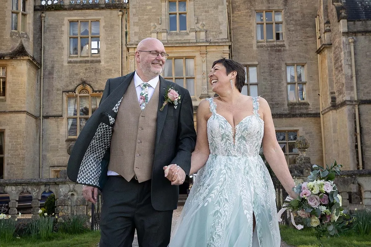 Bride and groom walking the grounds of their country house venue
