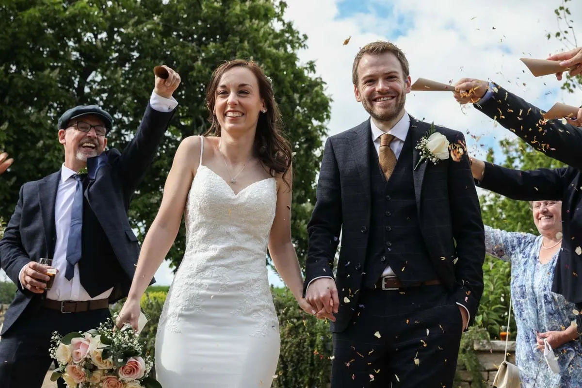 Bride and groom showered with confetti