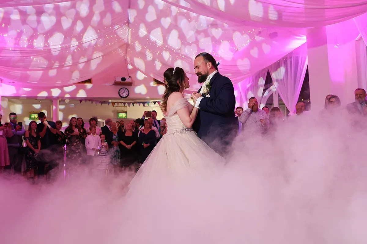 First dance under pink festoon lighting