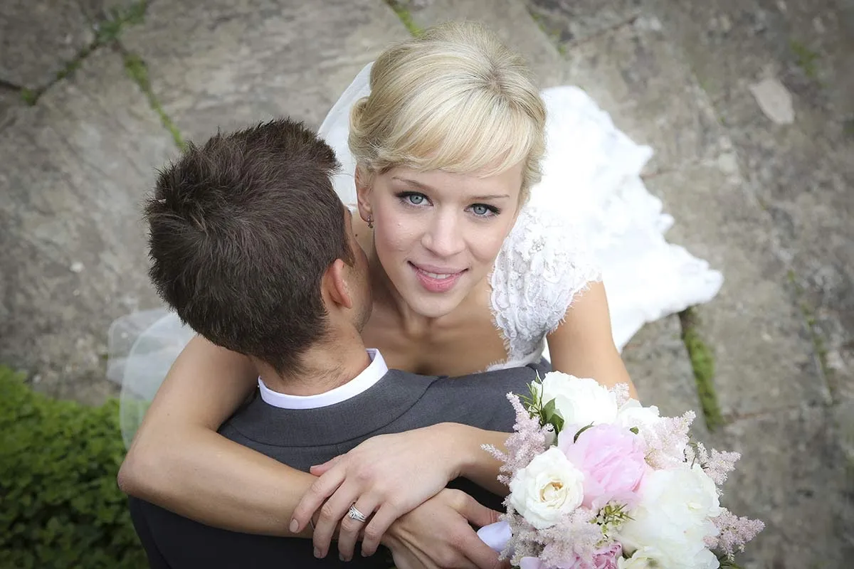 The bride hugged by a young guest