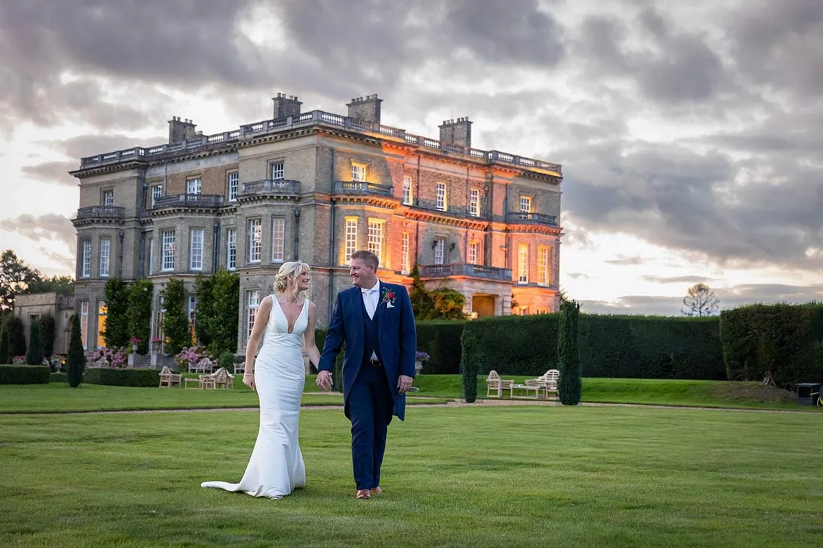 The couple in front of their country house venue at dusk
